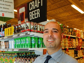 Michael Gencarelli, store manager Loblaws Princess Street Market, poses for a photo in front of the new 'Beer is Here' display in the store in Kingston on Tuesday. (Julia McKay/The Whig-Standard)