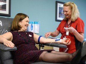 Health Minister Jane Philpott donates blood at the Canadian Blood Services, in Ottawa, on Monday, Dec. 14, 2015. THE CANADIAN PRESS/Justin Tang