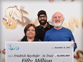 Annand Mayrhofer, Eric Mayrhofer and Friedrich Mayrhofer pose with their $50-million winning lottery cheque in Vancouver, Tuesday, Dec.15, 2015. THE CANADIAN PRESS/HO-British Columbia Lottery Corporation