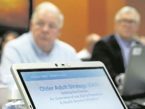 Luke Hendry/thee Intelligencer
A computer displays a report on the South East LHIN's Older Adult Strategy during a board meeting in Belleville Monday. Listening to discussion on the topic were board members Jack Butt, left, and Chris Salt.