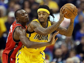 Pacers centre Jordan Hill (right) is guarded by Raptors centre Bismack Biyombo (left) during NBA action in Indianapolis on Monday, Dec. 14, 2015. (Brian Spurlock/USA TODAY Sports)