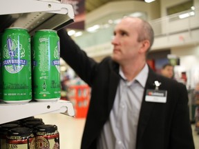 Blaine Cross, store manager of the College Square Loblaws supermarket, looks at some of the new selections of beer in store Tuesday. (Julienne Bay/Ottawa Sun)