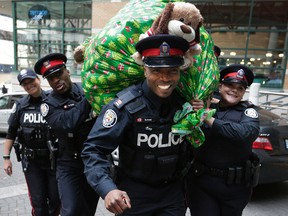 Officers at 55 Division deliver stuffed animals for Barry's bears in Toronto on Tuesday December 15, 2015. (Craig Robertson/Toronto Sun0