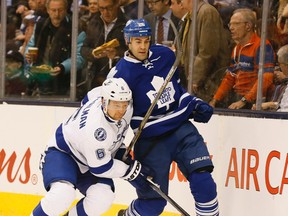 Anton Stralman takes Daniel Winnik into the boards as the Toronto Maple Leafs take on the Tampa Bay Lightning at the Air Canada Centre in Toronto on Dec. 15, 2015. (Stan Behal/Toronto Sun/Postmedia Network)