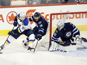 Dec 15, 2015; Winnipeg, Manitoba, CAN; Winnipeg Jets center Bryan Little (18) tries to take the puck away from St. Louis Blues right wing Vladimir Tarasenko (91) during the second period at MTS Centre. Mandatory Credit: Bruce Fedyck-USA TODAY Sports