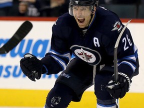 Winnipeg Jets' Blake Wheeler (26) celebrates after Chris Thorburn (22) scored against the St. Louis Blues during second period NHL hockey action, in Winnipeg, on Tuesday, Dec. 15, 2015. THE CANADIAN PRESS/Trevor Hagan