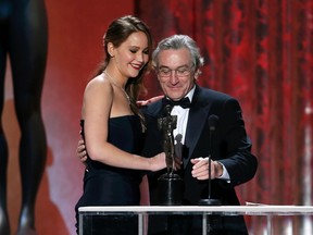 Jennifer Lawrence accepts the award for outstanding female actor in a leading role for "Silver Linings Playbook" from presenter Robert De Niro at the 19th annual Screen Actors Guild Awards in Los Angeles, California January 27, 2013. REUTERS/Lucy Nicholson