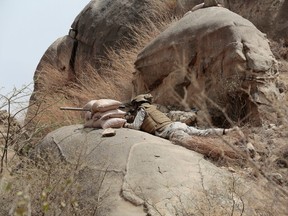 In this April 20, 2015 file photo, a Saudi soldier aims a machine-gun from behind a sandbag barricade in the border with Yemen in Jazan, Saudi Arabia. Saudi Arabia said Dec. 15, 2015, that 34 nations have agreed to form a new "Islamic military alliance" to fight terrorism with a joint operations center based in the kingdom's capital, Riyadh. (AP Photo/Hasan Jamali, File)