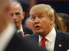 Donald Trump talks to reporters in the spin room following the CNN Republican presidential debate in Las Vegas on Dec. 15, 2015. (AP Photo/Mark J. Terrill)