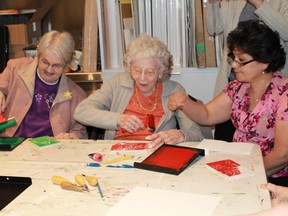 Billie Hildebrand, Helen Morningstar and Sylvia Roth learn how to block-print colourful Christmas cards on Dec. 9, part of the Judith and Norman Alix Art Gallery's Active Through Art program. 
REGINA DICKSON/SPECIAL TO SARNIA THIS WEEK