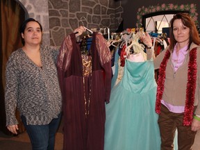 Costume Canada's Nicole Brown and the Deker Bauer Foundation's Teresa Ingles hold up dresses reserved for the foundation's New Year's Eve fundraiser event, the Unmask the Stigma Masquerade Ball. All money raised from the event will go towards the establishment of a 24-hour, seven days a week drop-in centre to help those in the community with mental health issues.  
CARL HNATYSHYN/SARNIA THIS WEEK