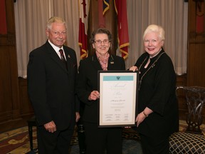 Seniors Affairs Minister Mario Sergio (left) and lieutenant governor of Ontario Elizabeth Dowdeswell present Londoner Marnie Sherritt with an Ontario Senior Achievement Award for her volunteer work November 26, 2015. (Submitted photo)