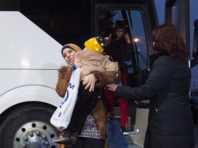 Newly-arrived Syrian refugees arrive at a hotel in Toronto on Tuesday, December 15, 2015. (THE CANADIAN PRESS/Nathan Denette)