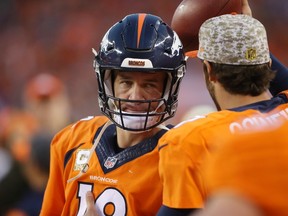 Denver Broncos quarterback Peyton Manning (18) looks at quarterback Brock Osweiler (17) on the sidelines after being benched during the second half against the Kansas City Chiefs at Sports Authority Field at Mile High. The Chiefs won 29-13. Chris Humphreys-USA TODAY Sports