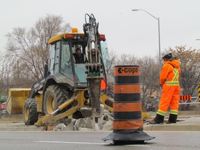 A temporary bypass is being installed on the southbound lanes of Indian Road Highway 402 overpass. The southbound lanes have been closed since the overpass was damaged when it was hit by an oversized tractor trailer load in late November. COPE Construction was on the job on Wednesday December 16, 2015 in Sarnia, Ont. City officials said permanent repairs by the Ontario Ministry of Transportation may not be completed until May or June.
Paul Morden/Sarnia Observer/Postmedia Network