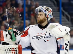 Washington Capitals goalie Braden Holtby squirts water during a timeout in the second period of an NHL hockey game against the Tampa Bay Lightning Saturday, Dec. 12, 2015, in Tampa, Fla. (AP Photo/Chris O'Meara)