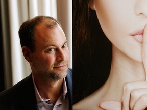 Ashley Madison founder Noel Biderman poses with a poster during an interview at a hotel in Hong Kong in this Aug. 28, 2013 file photo. REUTERS/Bobby Yip/Files