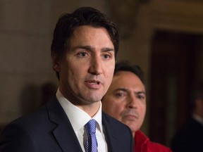 Assembly of First Nations National Chief Perry Bellegarde listen to Prime Minister Justin Trudeau respond to a question from the media following a on Parliament Hill in Ottawa Wednesday December 16, 2015. THE CANADIAN PRESS/Adrian Wyld