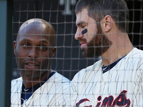 Twins' Torii Hunter, left, and Joe Mauer talk in the dugout during a game against the Royals in Minneapolis on Oct. 3, 2015. The Twins add protective netting above the dugouts at Target Field for 2016.  (AP Photo/Jim Mone)