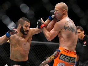 John Makdessi (left) punches Donald Cerrone during their lightweight mixed martial arts bout at UFC 187 in Las Vegas on May 23, 2015. (THE CANADIAN PRESS/AP/John Locher)
