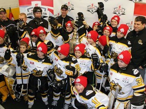 The Lambton Jr. Sting major atom hockey team was surprised by a visit from the Stanley Cup prior to practice at the Sarnia Sports and Entertainment Centre (on Wednesday, Dec. 16, 2015). Back row from left are coaches Steve McGrail, Todd Shanks, Mark Maitland, Shawn Vidler and Cory Pageau. Middle row from left are Isaac Oliphant, Adam Osler, Aaron Shanks, Jace McGrail, Jaxon Priddle, Garrett Pearce, Seth Ainsworth, Evan Morningstar, Luke Doan and Tanner Winegard. Front row from left are Carter La Rocque, Ryan Pageau, Logan O'Leary-Dilosa, Ryan Vidler, Landon Buckingham, Adam Maitland and Caiden Smit. Terry Bridge/Sarnia Observer/Postmedia Network