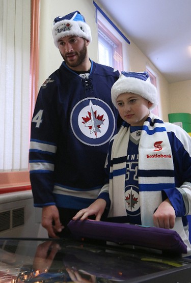 Winnipeg Jets forward Anthony Peluso checks out a pinball game with Zenon Horobec during a visit to the Rehabilitation Centre for Children on Wellington Crescent in Winnipeg on Wed., Dec. 16, 2015. Kevin King/Winnipeg Sun/Postmedia Network