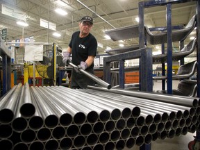 Production associate Rick Kell shapes metal tubes into instrument panel beams for Ford vehicles at Canada Tubeform  in London. (Free Press file photo)