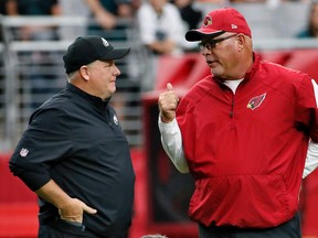 In this Oct. 26, 2014, file photo, Arizona Cardinals head coach Bruce Arians, right, talks with Philadelphia Eagles head coach Chip Kelly prior to a game in Glendale. (AP Photo/Matt York, File)
