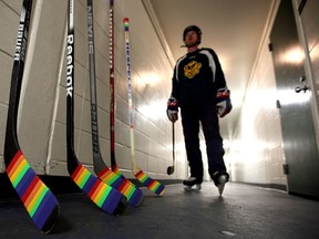 A player walks past Pride taped hockey stick at Claire Drake Arena n Edmonton, Alberta on Dec. 17, 2015. UofA Institute of Sexual Minority Studies and Services announced Pride Tape as a badge of support from the hockey world to the LGBTQ youth. Perry Mah/Edmonton Sun