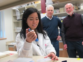 Shangmei Hou - PhD Candidate in Cell Biology (in the white lab coat), Dr. Thomas Hobman - professor of Cell Biology (in the blue sweater),Dr. Richard Rachubinski - Chair of the Department of Cell Biology (in the purple sweater)Photo supplied