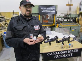 Barry Lamperd, CEO of Lamperd Less Lethal holds components of a munition on Wednesday December 16, 2015 in Sarnia, Ont., the company developed in collaboration with the Lambton College Bluewater Technology Access Centre. (Paul Morden/Sarnia Observer/Postmedia Network)