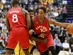 Toronto Raptors guard DeMar DeRozan, right, drives with the basketball while Raptors centre Bismack Biyombo, left, screens Indiana Pacers forward Paul George Monday, Dec. 14, 2015 in Indianapolis. (AP Photo/R Brent Smith)
