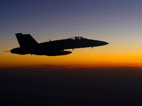 A Cold Lake CF-18 Hornet from Air Task Force-Iraq soars through the clouds over Iraq before commencing the next mission during Operation IMPACT on January 23, 2015. DND/Combat Camera