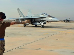 A Canadian Armed Forces CF-18 Fighter jet from 409 Squadron taxis after landing, in Kuwait, on October 28, 2014. Two CF-18s struck a fighting position belonging to the Islamic State in Iraq and the Levant, northwest of occupied Mosul, the embattled country's second-largest city on Thursday, Dec. 17, 2015. THE CANADIAN PRESS/HO, DND-MND
