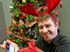 Kyle Mayer, the marketing manager for CoreSolutions Software Inc. shows off their new gift shopping app, Gift. (MIKE HENSEN, The London Free Press)