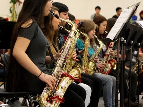 Students in McNally High School's jazz band perform a holiday medley during the school's annual pancake breakfast on Thursday, Dec. 17, 2015. Proceeds from the student led breakfast support Adopt-A-Teen.