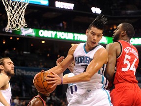 Charlotte Hornets guard Jeremy Lin fights Toronto Raptors forward Patrick Patterson for the rebound during the first half of the game at Time Warner Cable Arena in Charlotte on Dec. 17, 2015. (Sam Sharpe/USA TODAY Sports)