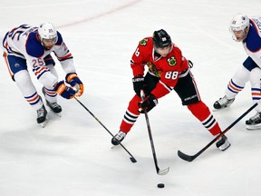 Oilers denfenceman Darnell Nurse and centre Mark Letestu converge on Blackhawks forward Patrick Kane during the first period of Thursday's game in Chicago. (USA TODAY SPORTS)