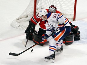 Oilers centre Mark Letestu is stymied by Blackhawks goaltender Mark Crawford during Thursday's game in Chicago. (USA TODAY SPORTS)