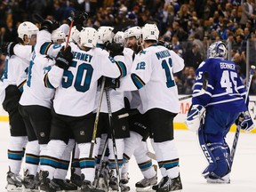 The San Jose Sharks celebrate after Brent Burns scores the overtime winner against the Maple Leafs on Thursday at the Air Canada Centre. It was the Sharks' league-leading 12th road win of the season. (STAN BEHAL/TORONTO SUN)
