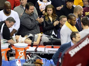 Ellie Day, wife of golfer Jason Day (not pictured), leaves the arena on a stretcher after she was run into by Cleveland Cavaliers forward LeBron James while she sat in the front row during a game between the Cleveland Cavaliers and the Oklahoma City Thunder at Quicken Loans Arena in Cleveland on Dec. 17, 2015. (David Richard/USA TODAY Sports)