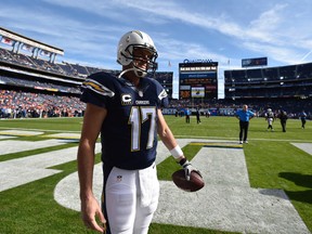 This Dec. 14, 2014 file photo shows San Diego Chargers quarterback Philip Rivers warms up before an NFL football game against the Denver Broncos in San Diego. (AP Photo/Denis Poroy)
