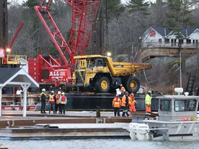 A barge and crane is used to lift a truck from the Killarney channel in Killarney, Ont. on Thursday December 17, 2015. The submerged truck has lain in the channel since Dec. 7 after sliding off a barge. John Lappa/Sudbury Star/Postmedia Network