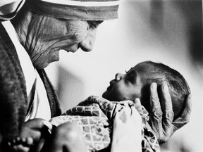 In this 1978, file photo, Mother Teresa, head of the Missionaries of Charity order, cradles an armless baby girl at her order's orphanage in what was then known as Calcutta, India, in 1978. Pope Francis has signed off on the miracle needed to make Mother Teresa a saint, giving the nun who cared for the poorest of the poor one of the Catholic Church's highest honours just two decades after her death. (AP Photo/Eddie Adams, File)