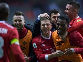 Canada's Will Johnson, centre, Cyle Larin, front right, and Marcus Haber, back right, celebrate after defeating Honduras 1-0 during a CONCACAF 2018 World Cup qualifying soccer match in Vancouver, B.C., on Friday November 13, 2015. THE CANADIAN PRESS/Darryl Dyck