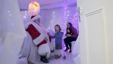 Five-year-old Leila Matheson reacts as she meets actor John Field, dressed as Santa Claus, at a Christmas grotto at a dental practice in north London, Britain, Dec. 12, 2015.  REUTERS/Stefan Wermuth