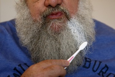 Actor John Field colours his beard using a toothbrush as he dresses as Santa Claus at the Wetland Centre in London, Britain, Dec. 5, 2015. REUTERS/Stefan Wermuth