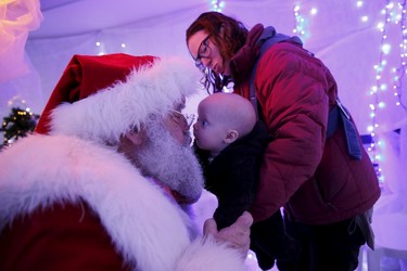Six-month-old Cleo Matheson kisses actor John Field, dressed as Santa Claus, at a Christmas grotto at a dental practise in north London, Britain, Dec. 12, 2015. When   REUTERS/Stefan Wermuth