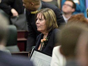 Minister of Energy Marg McCuaig-Boyd leaves the room after the speech from the throne in Edmonton, Alta., on June 15, 2015. The minister says oil and gas companies can safely put together their winter drilling budgets knowing current royalty rates will stay put through 2016 despite a review of the issue by a four-member panel. THE CANADIAN PRESS/Jason Franson
