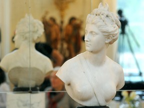The marble bust of the antique goddess Diana is presented during a ceremony of return at the Lazienki Palace in Warsaw, Poland, Friday, Dec. 18, 2015.  The 18th-century marble bust of the goddess Diana looted by the Nazis in 1940 has returned to Warsaw from Vienna, where it recently surfaced at an auction house. The return of the sculpture, by French master Jean-Antoine Houdon and valued at some 250,000 euro (US dlrs 271,000), is the latest development in Poland's yearslong effort to retrieve tens of thousands of works of art looted from museums and private collections in the nation's tumultuous history, most recently during World War II.  (AP Photo/Alik Keplicz)